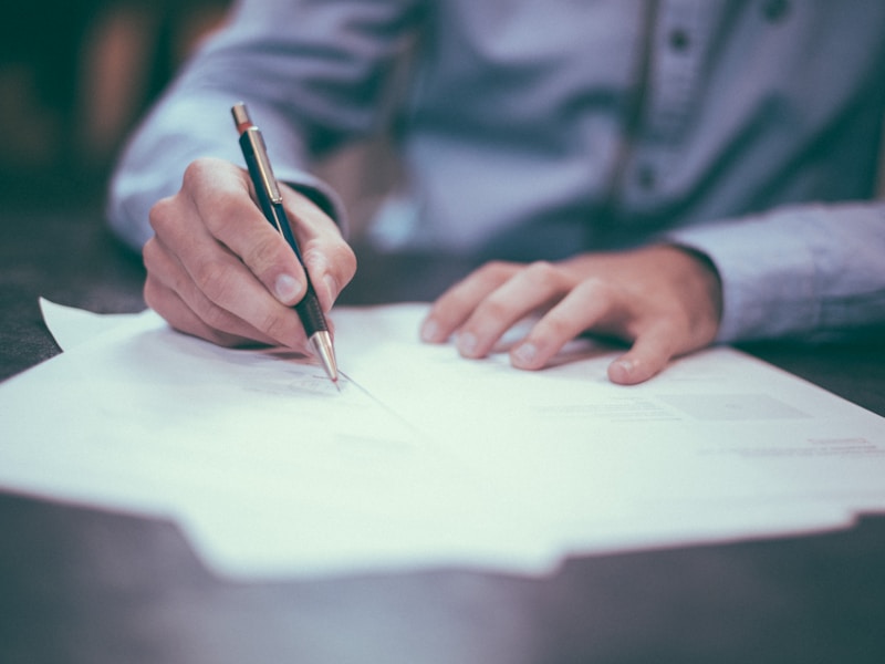 Contract documents and pen on a desk